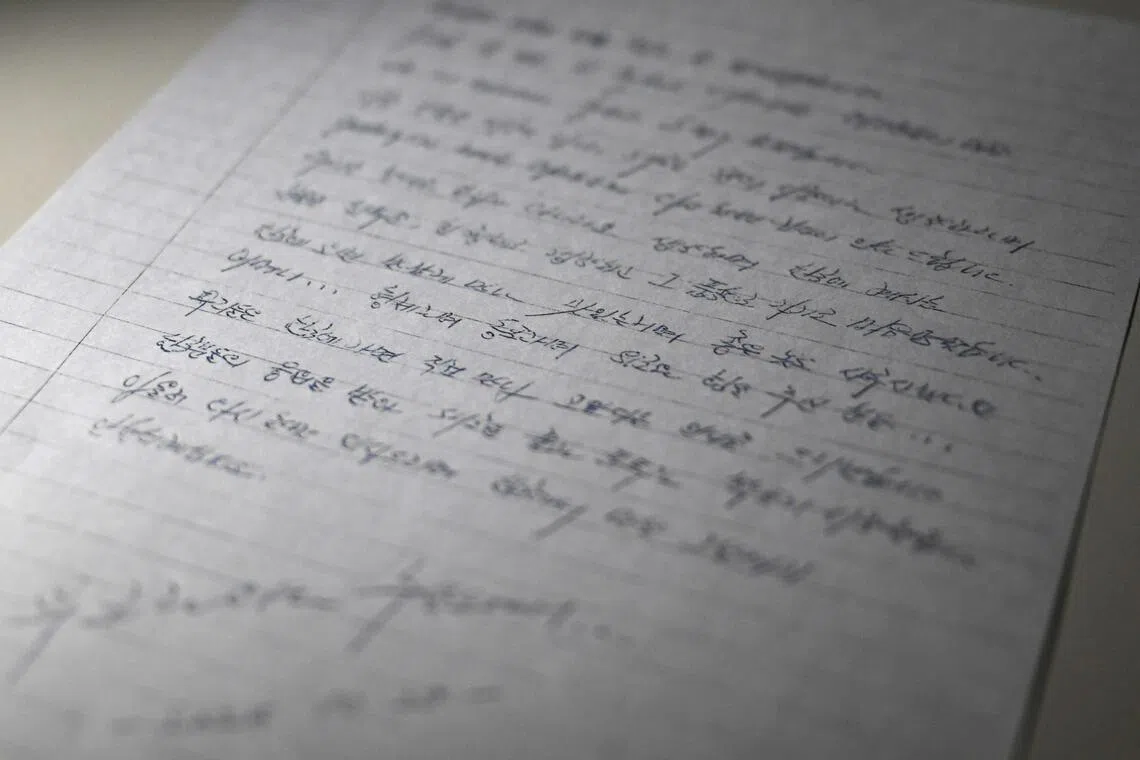 This photo illustration taken in Seoul on Dec 24, 2025, shows a copy of a letter written on Oct 28, 2025, by North Korean prisoners of war in Ukraine.