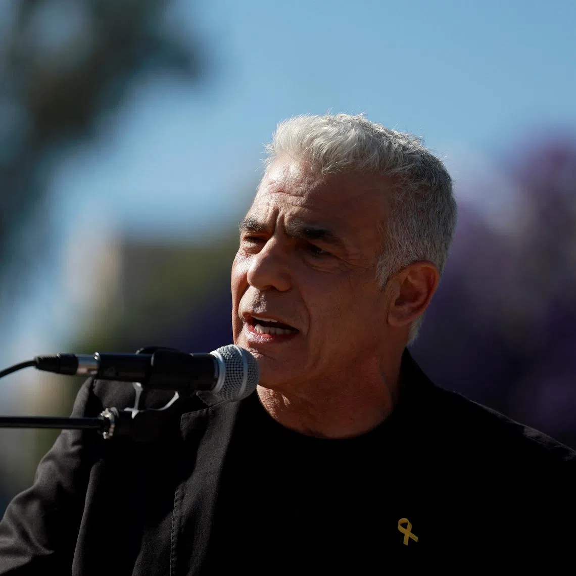 Israeli opposition leader Yair Lapid speaks during an annual Pride and Tolerance March, under the slogan \"Born to be Free\" calling for the swift return of hostages seized during the deadly October 7 attack by Palestinian Islamist group Hamas from Gaza, in Jerusalem, May 30, 2024. REUTERS/Ammar Awad/File Photo