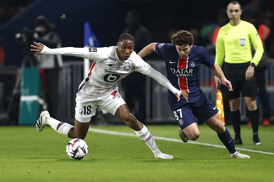 FILE PHOTO: Soccer Football - Ligue 1 - Paris St Germain v Lille - Parc des Princes, Paris, France - March 1, 2025 Lille's Bafode Diakite in action with Paris St Germain's Joao Neves REUTERS/Abdul Saboor/File Photo