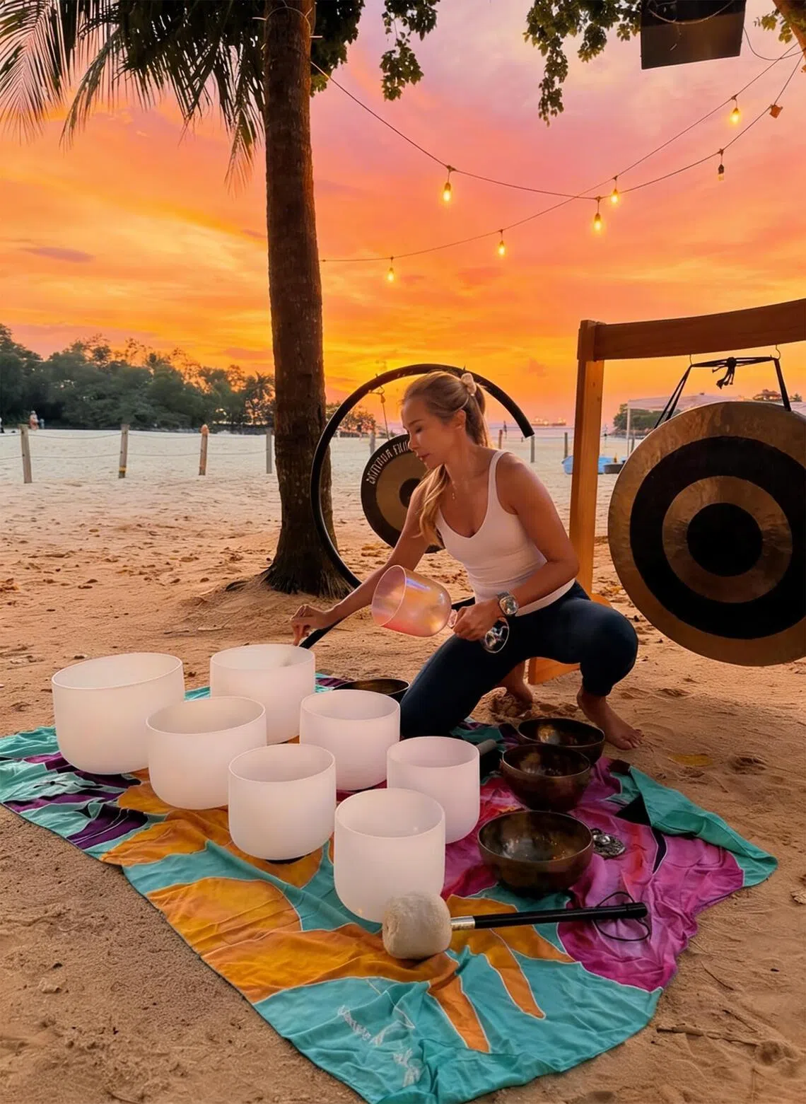 Wellness advocate Dawn Sim, who is in her 40s, leads the sound bath at FOC by the Beach’s Sunset Watch Party.