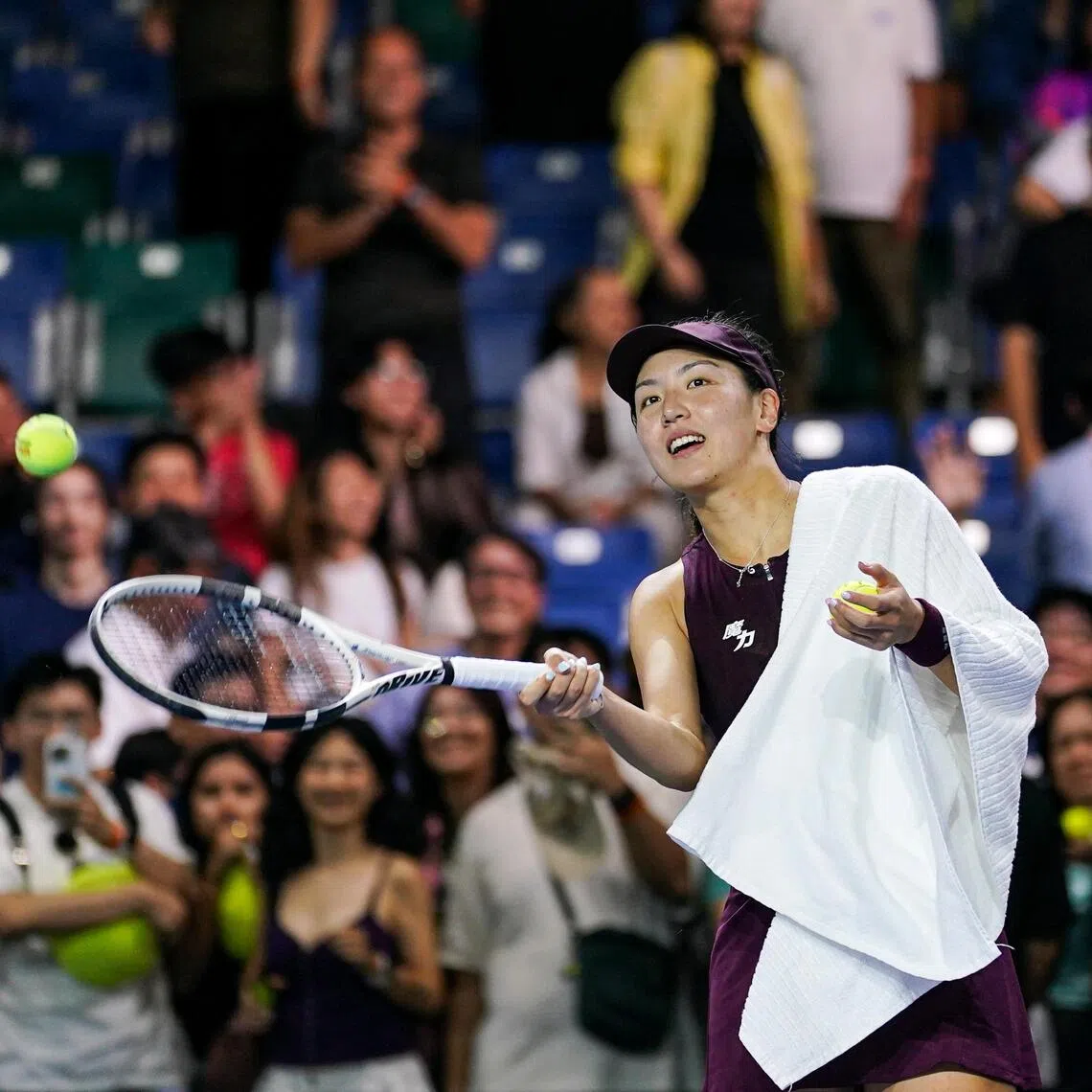 Wang Xinyu hitting tennis balls to fans after winning against Donna Vekic during their Singapore Tennis Open women’s singles Round of 32 match at OCBC Arena on Sept 22.