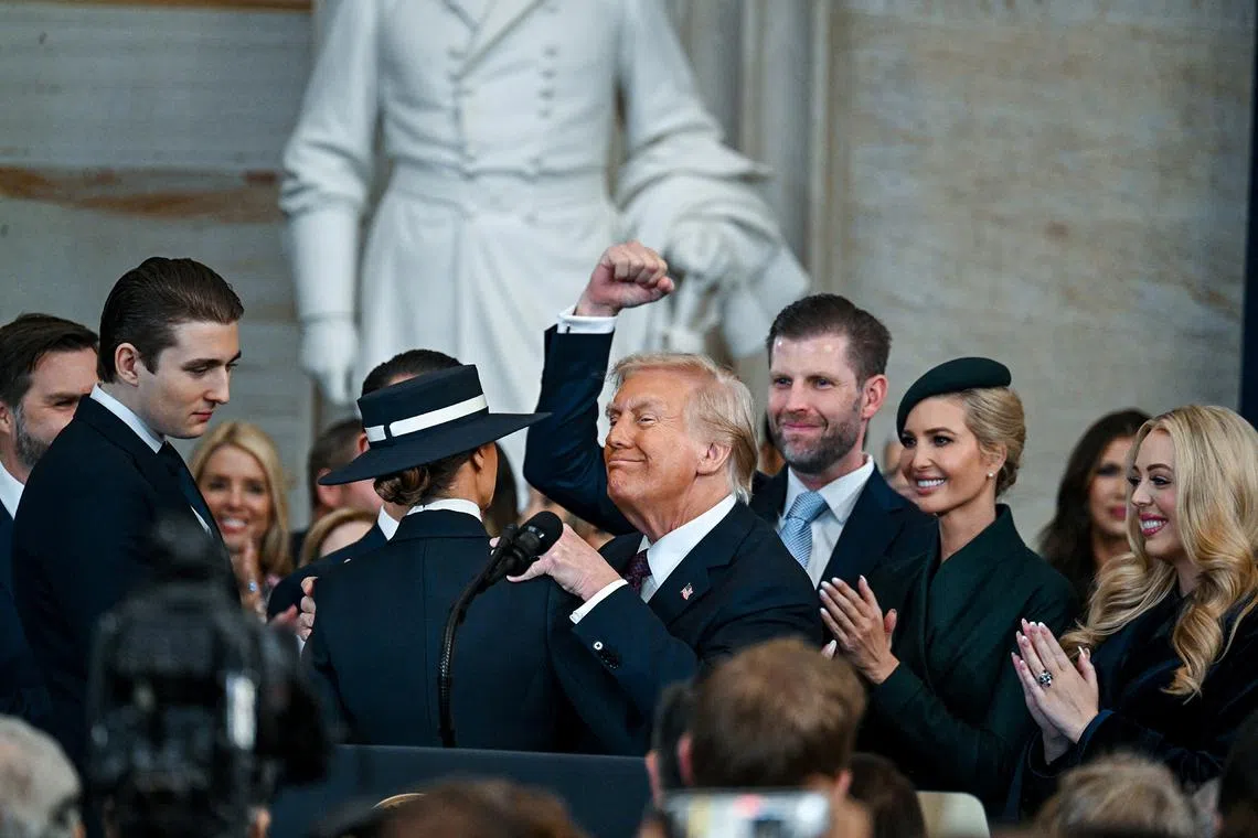 US President Donald Trump celebrates with family after being sworn in inside the US Capitol Rotunda on Jan 20, 2025.