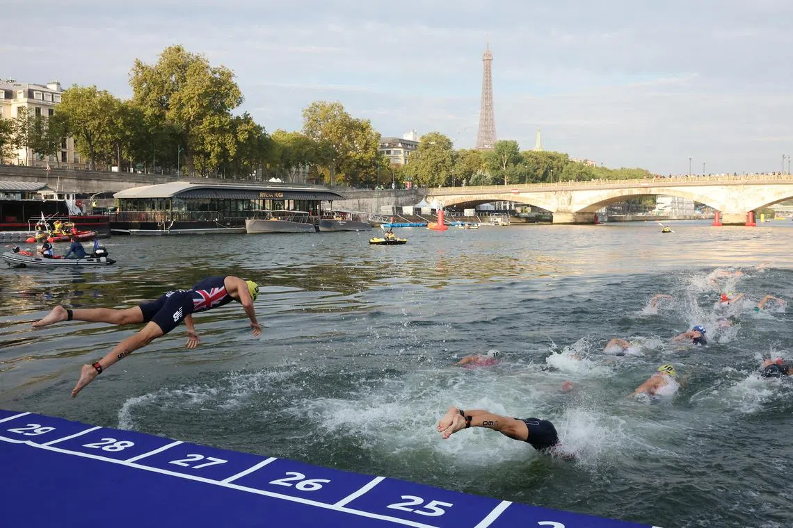 Athletes competing in the elite men triathlon test event in Paris' River Seine on Aug 18, 2023. An event the next day was called off owing to sewage contamination.