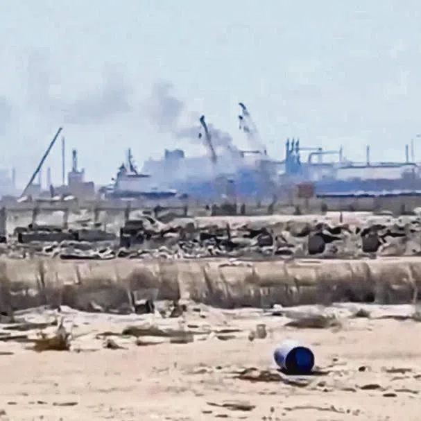 Smoke rises from a gas tanker after a drone strike at Damietta port, Egypt, on July 29.