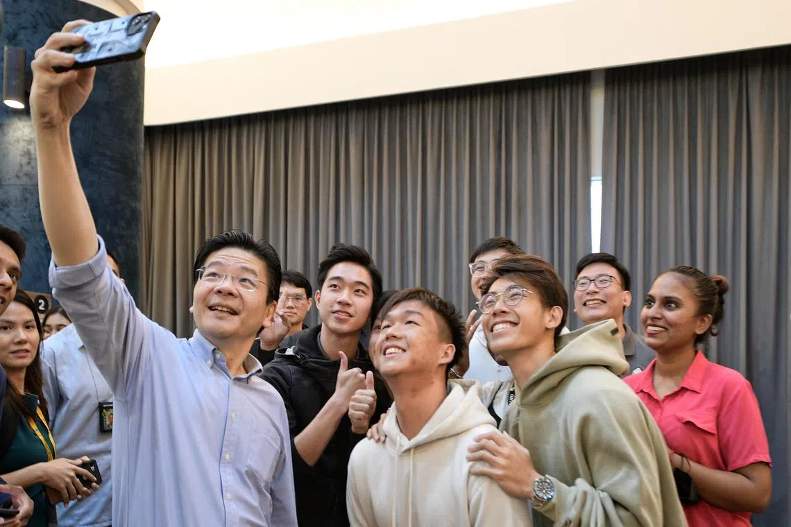 DPM Lawrence Wong taking a selfie during the launch of Mentoring SG at the National Mentoring Summit 2022.