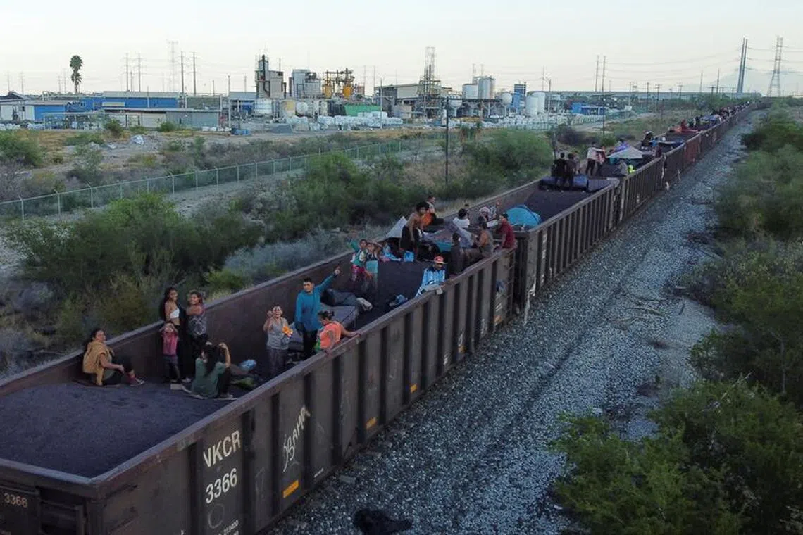 Asylum seekers heading to the U.S. travel on a train after thousands of migrants crossed into the United States in recent days, in El Carmen, Mexico September 21, 2023. REUTERS/Daniel Becerril/File Photo