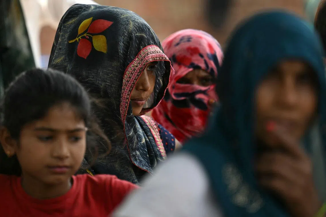 CORRECTION / In this photograph taken on May 6, 2024, women from India's marginalised Dalit caste are pictured in Ayela village on the outskirts of Agra. More than two-thirds of India's 1.4 billion people are estimated to be on the lower rungs of a millennia-old social hierarchy that divides Hindus by function and social standing. Modi's Hindu-nationalist Bharatiya Janata Party (BJP) has established itself as India's dominant political force with a different pitch: think of your religion first, and caste second. (Photo by Money SHARMA / AFP) / TO GO WITH: India-Vote-Caste, FOCUS Arunabh SAIKIA / “The erroneous mention[s] appearing in the metadata of this photo by Money SHARMA has been modified in AFP systems in the following manner: [clarifying caption to add reference of Dalit as the marginalised caste]. Please immediately remove the erroneous mention[s] from all your online services and delete it (them) from your servers. If you have been authorized by AFP to distribute it (them) to third parties, please ensure that the same actions are carried out by them. Failure to promptly comply with these instructions will entail liability on your part for any continued or post notification usage. Therefore we thank you very much for all your attention and prompt action. We are sorry for the inconvenience this notification may cause and remain at your disposal for any further information you may require.”