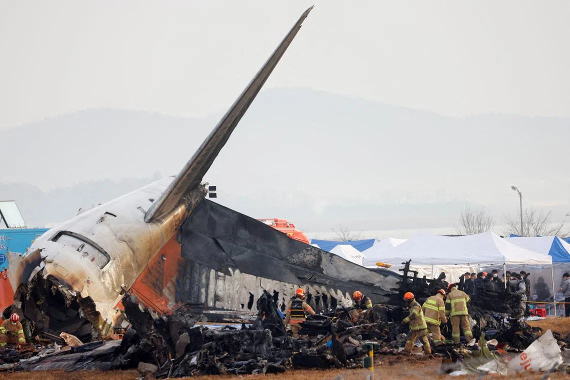 FILE PHOTO: People work at the site where an aircraft went off the runway and crashed at Muan International Airport, in Muan, South Korea, December 30, 2024. REUTERS/Kim Soo-hyeon/File Photo