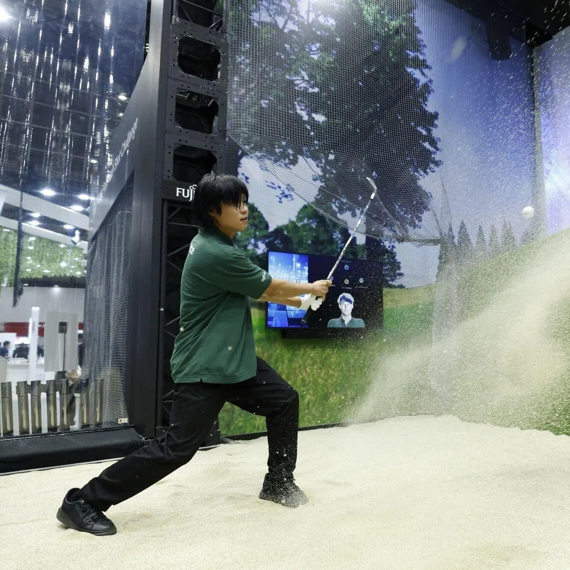 A booth attendant demonstrating Fujitsu’s Human Motion Analytics data analysis platform and the AI agent at the Combined Exhibition of Advanced Technologies in Chiba, Japan, on Oct 14.