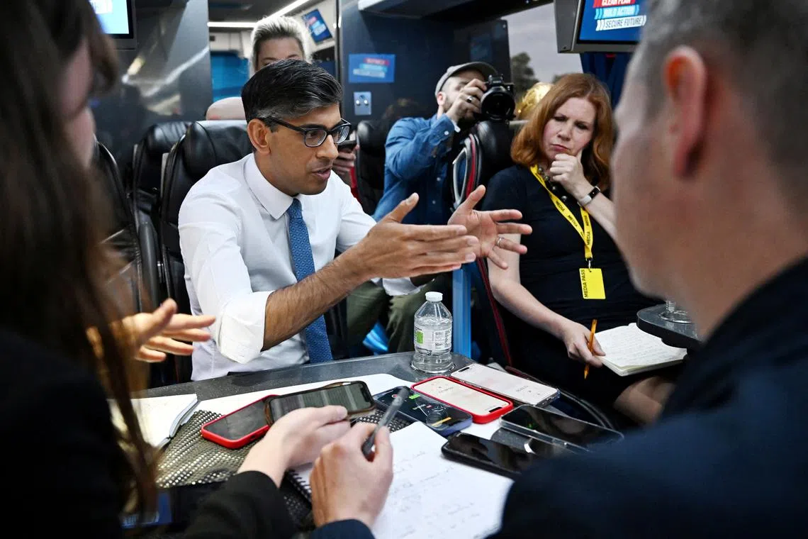 British Prime Minister Rishi Sunak speaks to journalists on the campaign bus following the launch of the Welsh Conservatives General Election manifesto on June 21, 2024, near Rhyl, Britain. Leon Neal/Pool via REUTERS