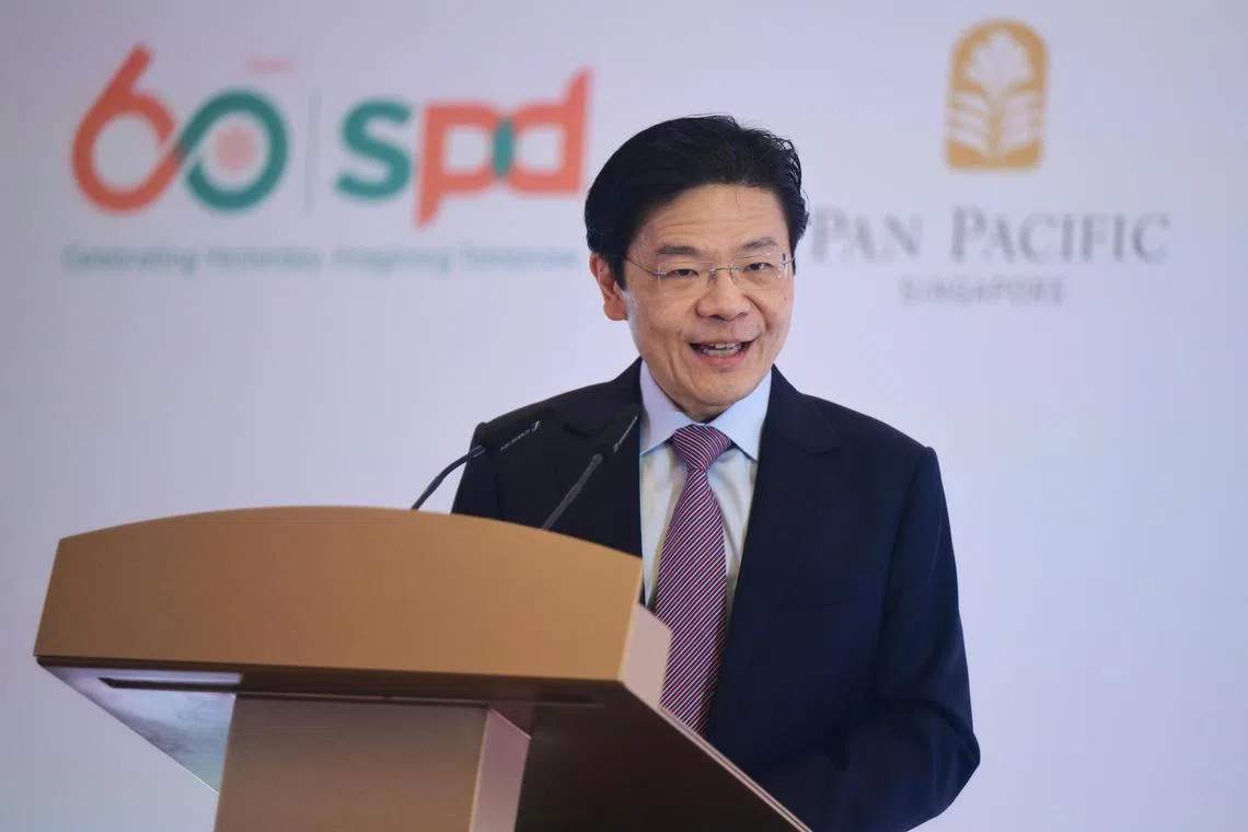 PM Lawrence Wong gives a speech at the SPD 60th anniversary dinner at Pan Pacific Singapore on Oct 28. 

ST PHOTO: AZMI ATHNI