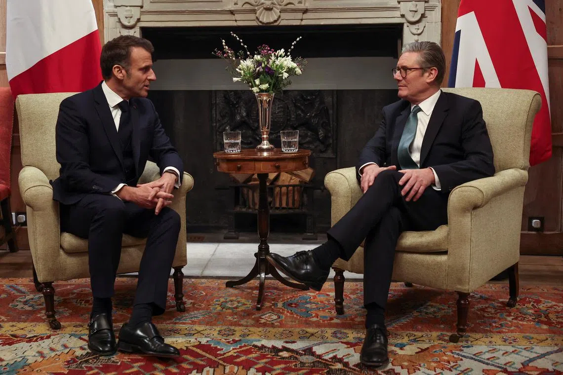 FILE PHOTO: British Prime Minister Keir Starmer and French President Emmanuel Macron talk during a bilateral meeting at Chequers, near Aylesbury, Britain, January 9, 2025. REUTERS/Toby Melville/Pool/File Photo