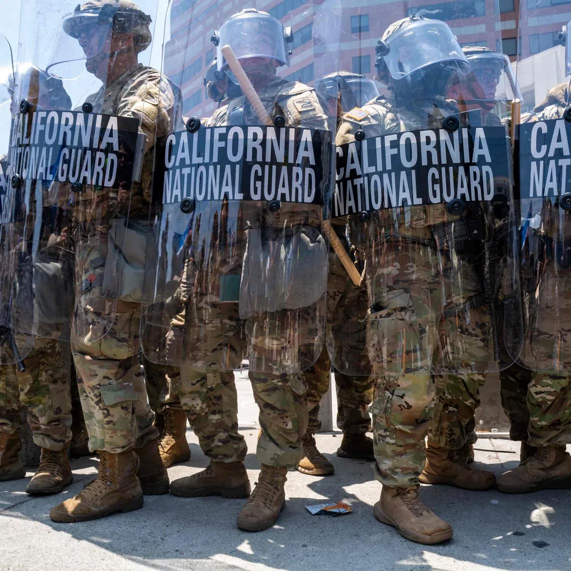 The National Guard, police and protesters stand off outside of a downtown jail in Los Angeles.