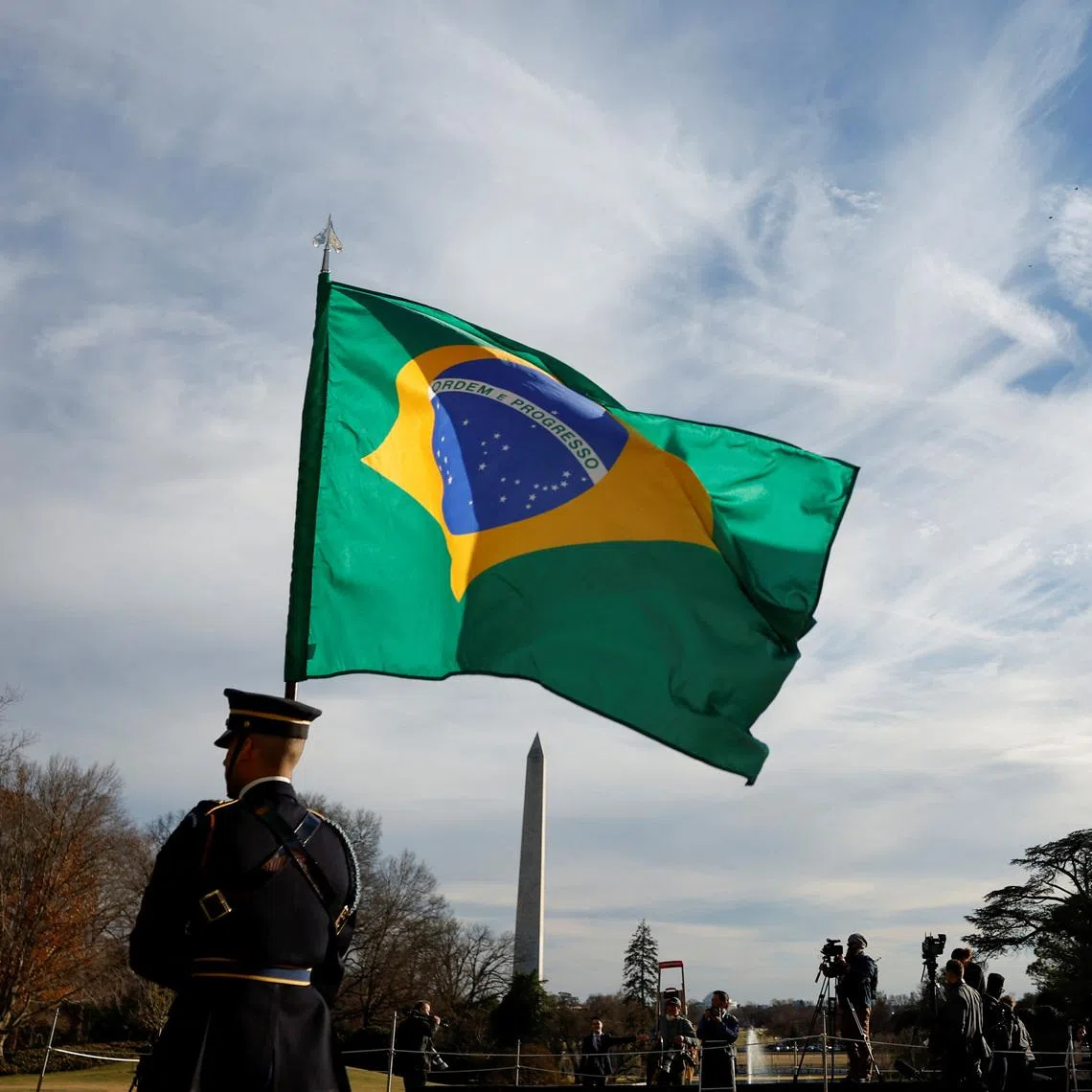 FILE PHOTO: Guards hold U.S. and Brazilian flags at the White House in Washington, U.S., February 10, 2023.  REUTERS/Evelyn Hockstein/ File Photo