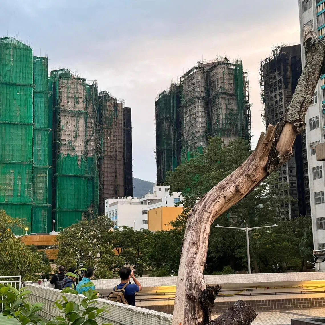 mfsplit - The burnt buildings and the sole unburnt one (far left) of Wang Fuk Court housing estate, site of the deadly blaze in Tai Po, Hong Kong, on Dec 2, 2025. 

CREDIT: COURTESY OF BENJAMIN THAM