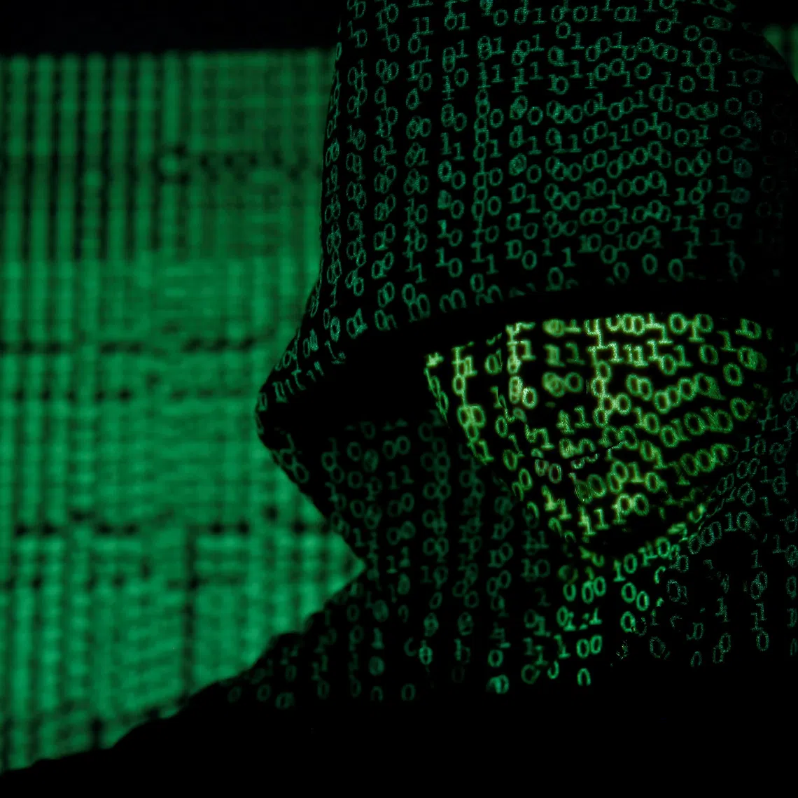 A projection of cyber code on a hooded man is pictured in this illustration picture taken on May 13,  2017. REUTERS/Kacper Pempel/Illustration