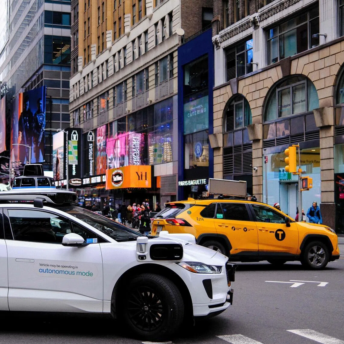 A Waymo autonomous self-driving Jaguar electric vehicle is seen in the Manhattan borough of New York City, on December 13, 2025. (Photo by CHARLY TRIBALLEAU / AFP)