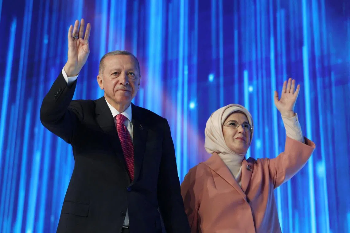 Turkish President Tayyip Erdogan, accompanied by his wife Emine Erdogan, greets the audience during a meeting of his ruling AK Party to announce the party's election manifesto ahead of the May 14 elections, in Ankara, Turkey April 11, 2023. Presidential Press Office/Handout via REUTERS ATTENTION EDITORS - THIS PICTURE WAS PROVIDED BY A THIRD PARTY. NO RESALES. NO ARCHIVES.
