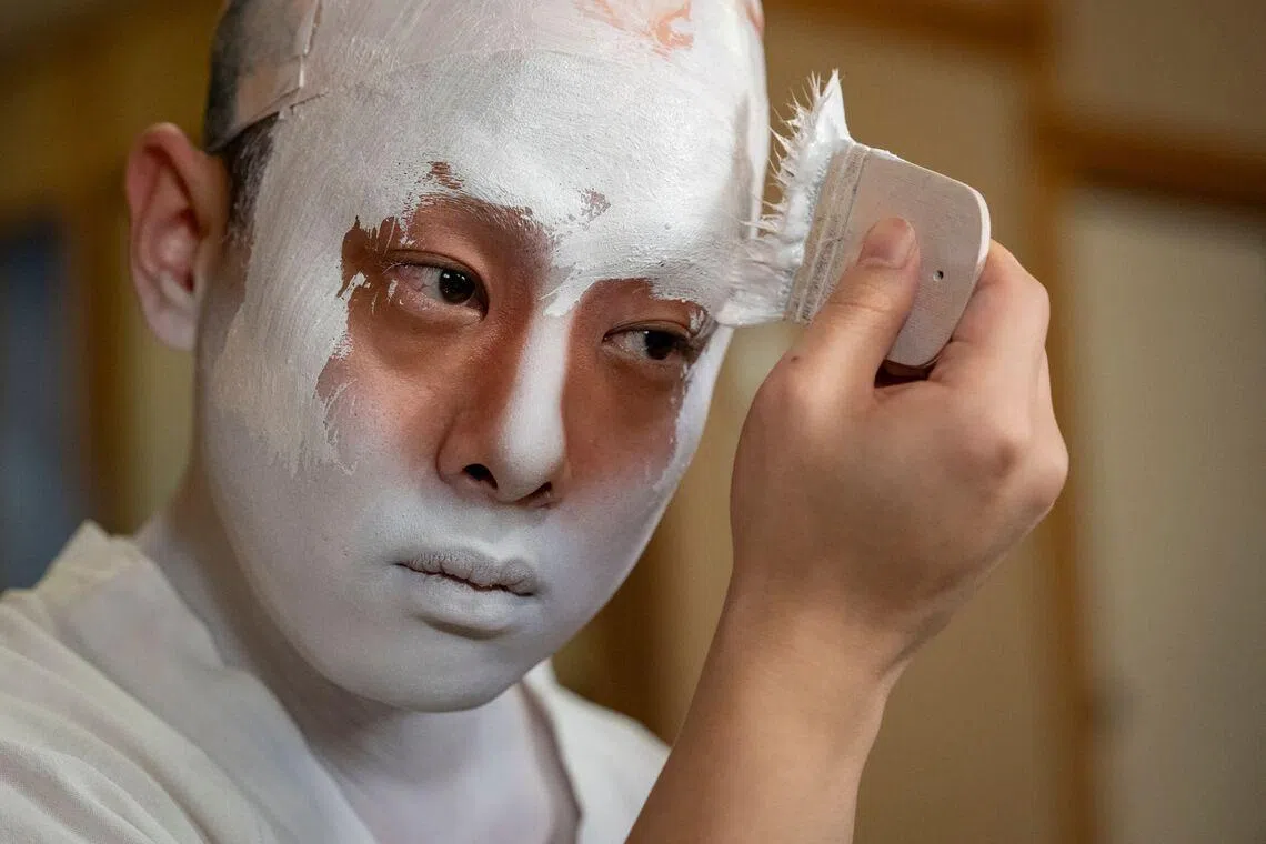 This picture released on April 23, 2026 showing kabuki actor Tanenosuke Nakamura applying makeup before his performance at the Kabuki-za Theatre in Tokyo, Japan. 