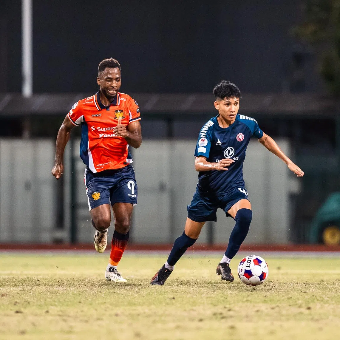 Gloire Amanda (left) in action for Hougang United in the Singapore Premier League in a match against the Young Lions on Jan 30. 