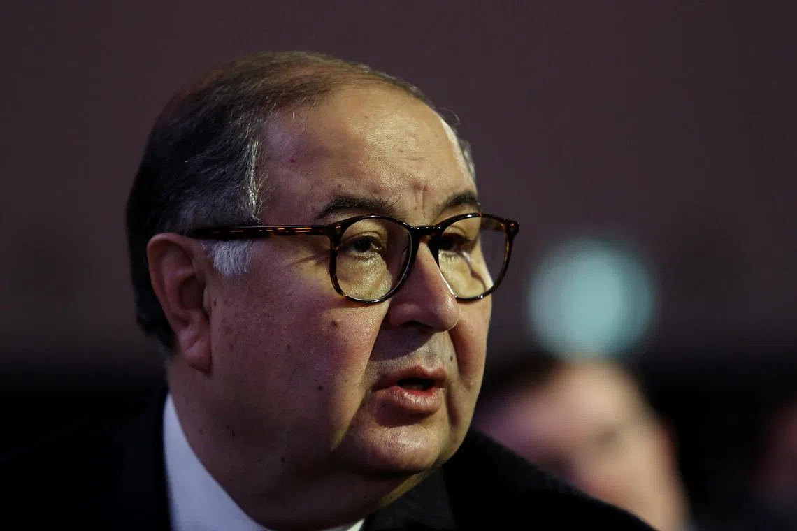 Russian billionaire Alisher Usmanov speaks with an attendee before the opening session on the first day of the World Economic Forum (WEF) in Davos, Switzerland, on Wednesday, Jan. 23, 2013. World leaders, Influential executives, bankers and policy makers attend the 43rd annual meeting of the World Economic Forum in Davos, the five day event runs from Jan. 23-27. Photographer: Chris Ratcliffe/Bloomberg