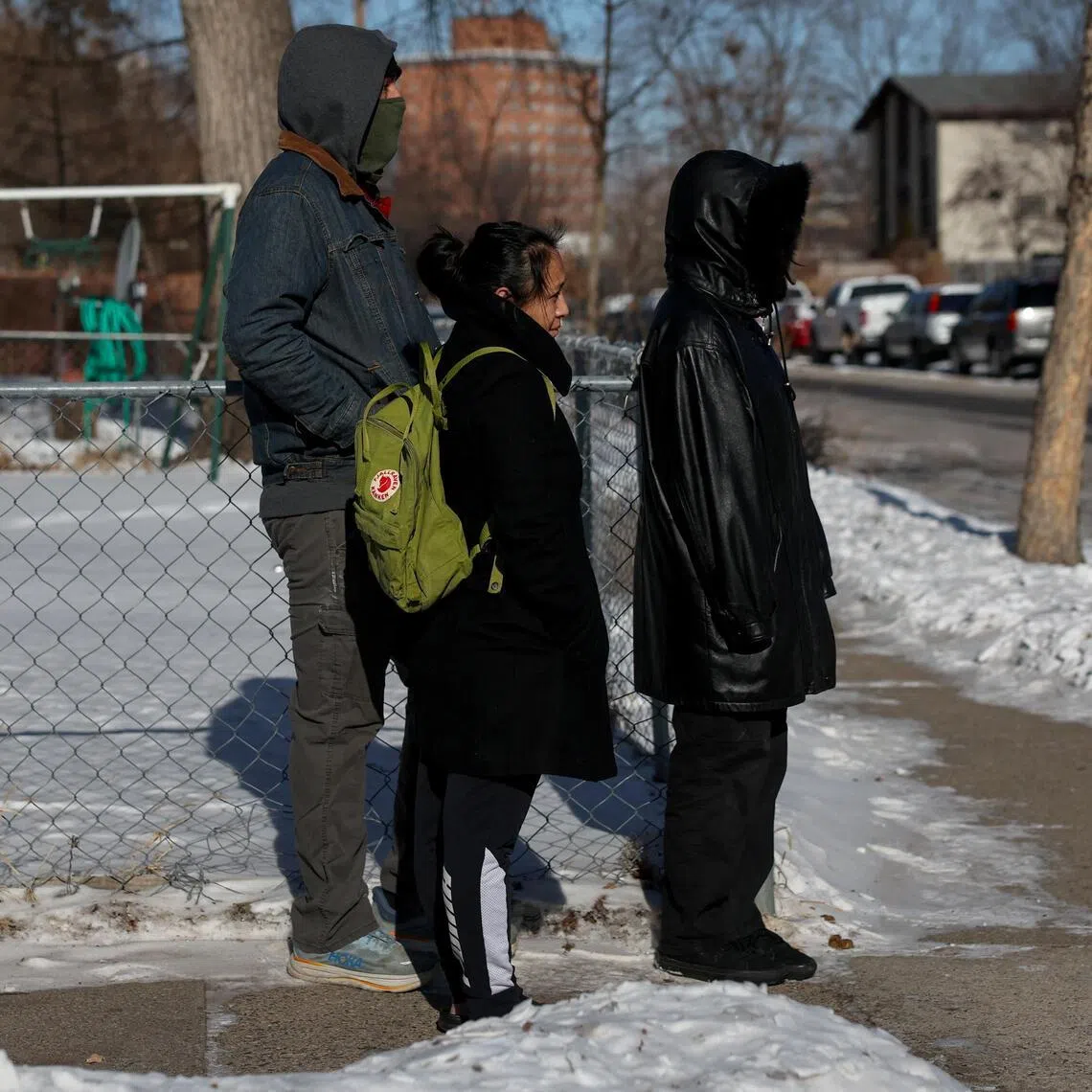 Residents stand as local community activists alert neighbours about an SUV with tinted windows, which observers believe to be a federal law enforcement vehicle, after Mr Alex Pretti was fatally shot by federal immigration agents trying to detain him on Jan 24, 2026.