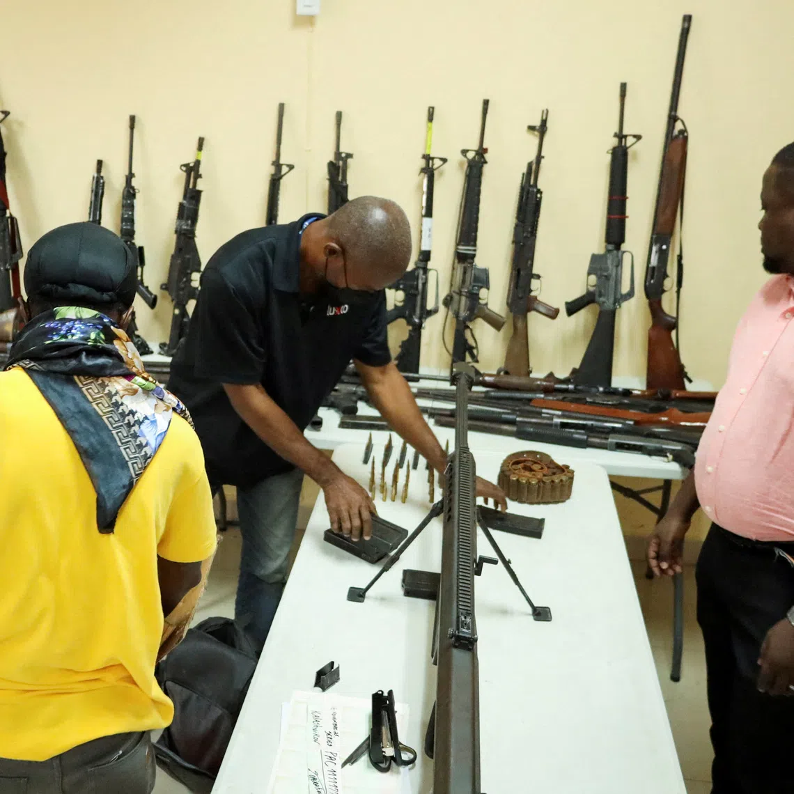 Weapons and ammunition seized during different operations against gangs are presented during a press conference, in Port-au-Prince, Haiti, November 28, 2025. REUTERS/Fildor Pq Egeder