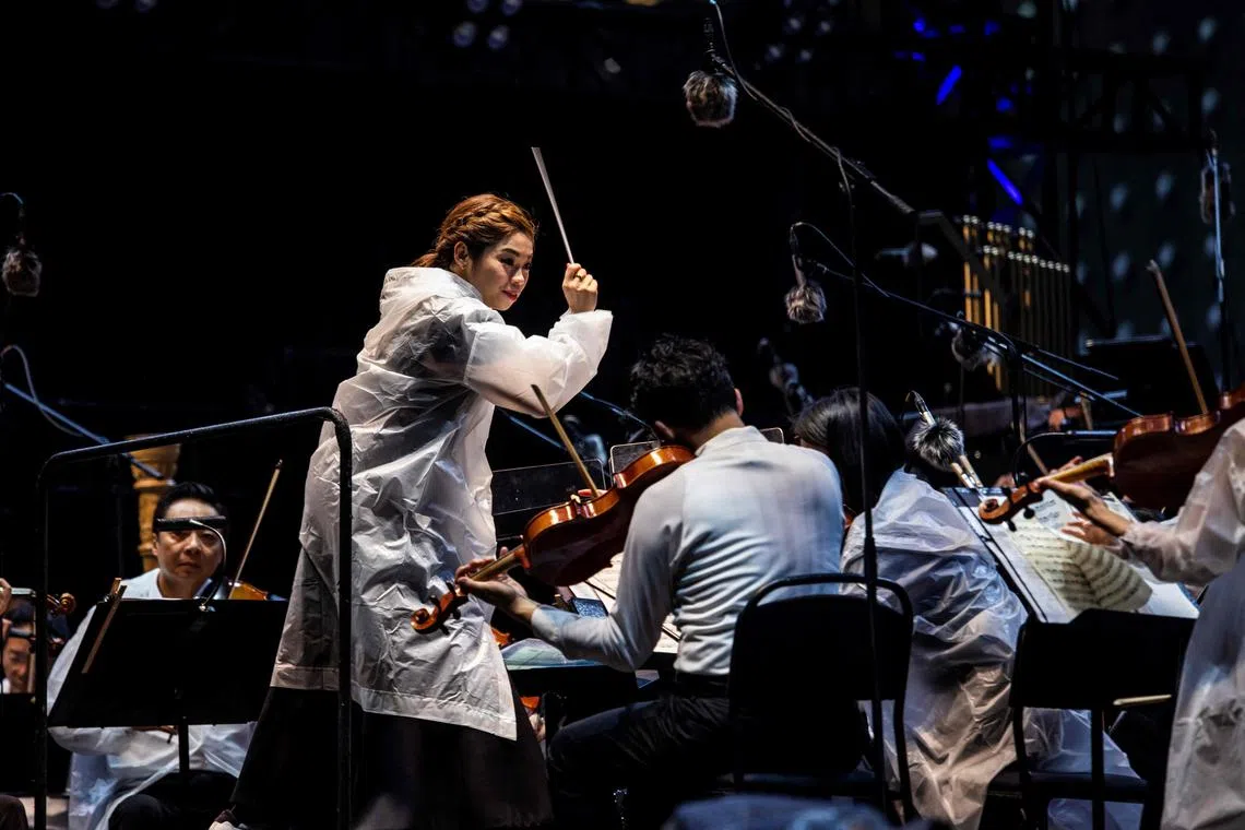 Conductor Elim Chan conducts the Hong Kong Philharmonic at an outdoor concert at the central harbour front in Hong Kong on Nov 16.