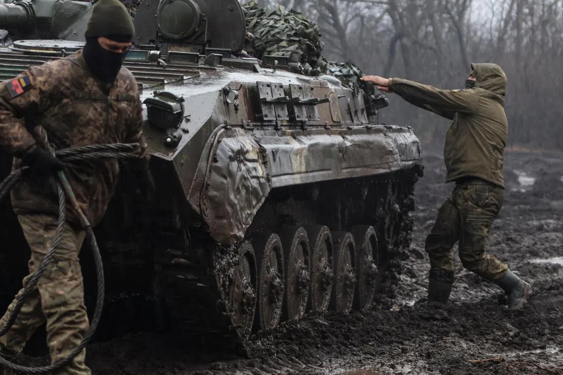 Ukrainian servicemen are seen next to an infantry fighting vehicle, near the front-line town of Bakhmut, in Ukraine's Donetsk region.