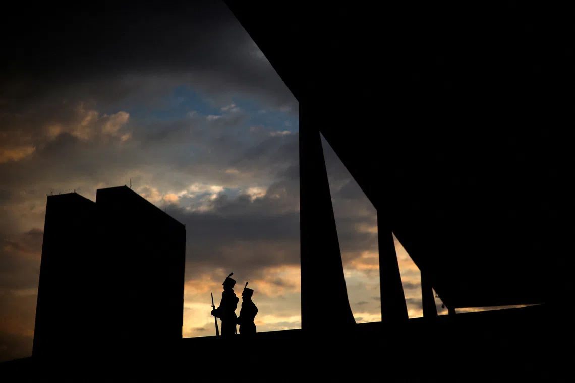 FILE PHOTO: Soldiers of the Presidential Guard stand guard at the Planalto Palace as the National Congress is seen in the background at sunset in Brasilia, Brazil, September 2, 2026. REUTERS/Adriano Machado/File Photo