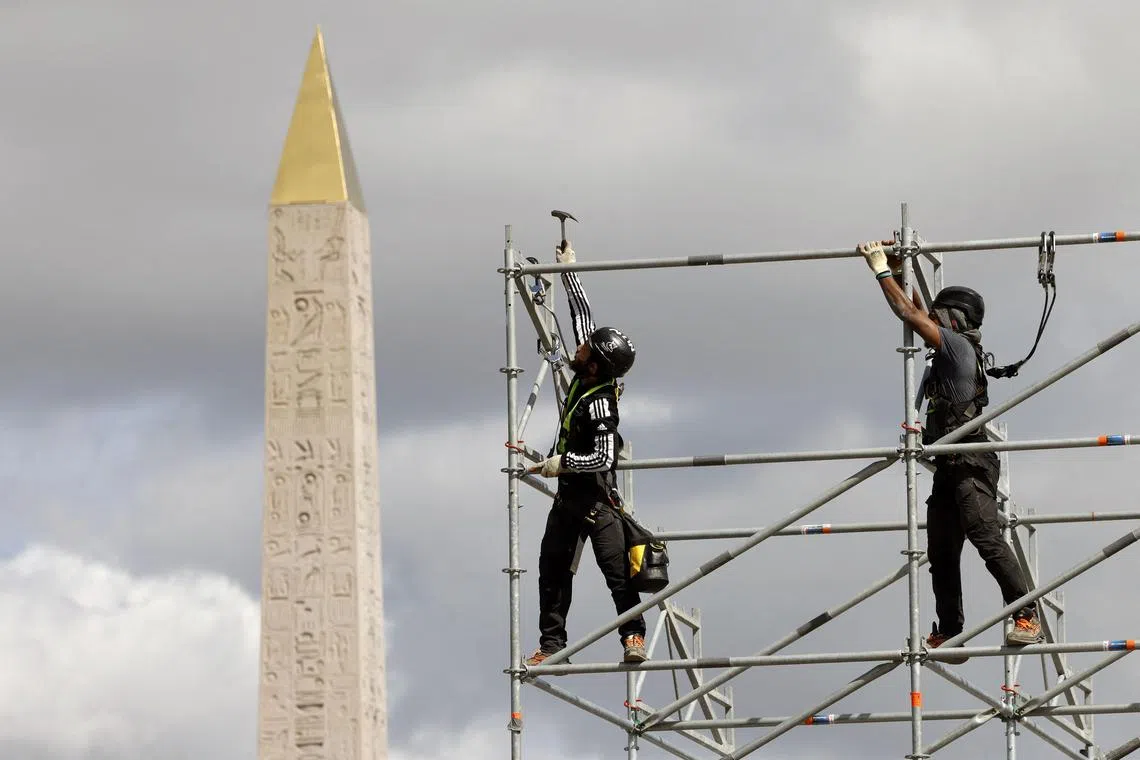 Workers building up the bleachers in front of the obelisque at the construction site of La Concorde Urban Parc site for the upcoming Paris 2024 Olympics, in Paris on April 10, 2024. The Urban Park will host street skateboarding, BMX freestyle, 3×3 basketball and Breaking Olympic events in the four arenas set up at central Paris' Place de La Concorde.