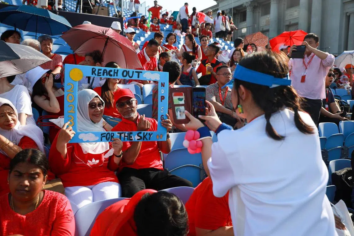 Spectators waiting for the start of the National Day Parade at the Padang, on Aug 9, 2023. ST PHOTO: RYAN CHIONG