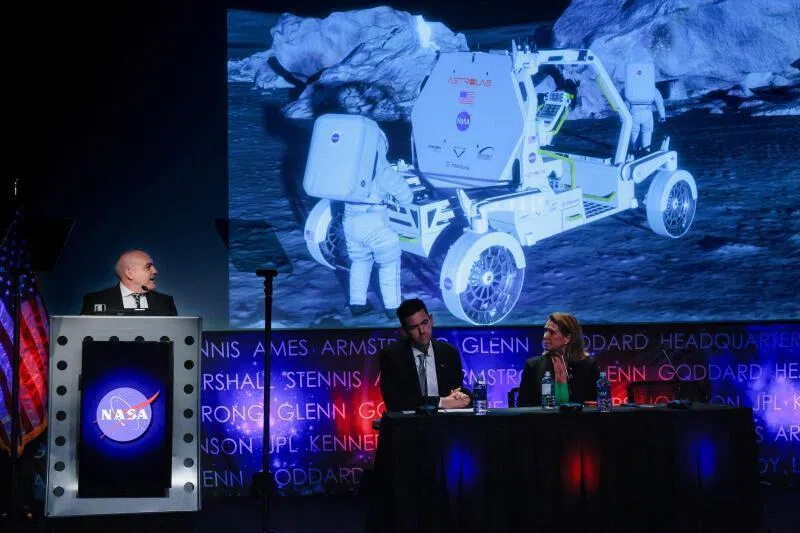 NASA Moon Base Program Executive Carlos Garcia-Galan (left) presenting concept animations of the Astrolab Crewed Lunar Vehicle on May 26 during a news conference with Administrator Jared Isaacman (second from left) at NASA headquarters in Washington DC.