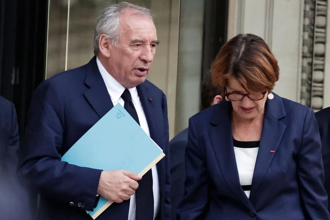 France's Prime Minister Francois Bayrou, flanked by Agriculture and Food Sovereignty Minister Annie Genevard (right), leaves the National Assembly after the vote.