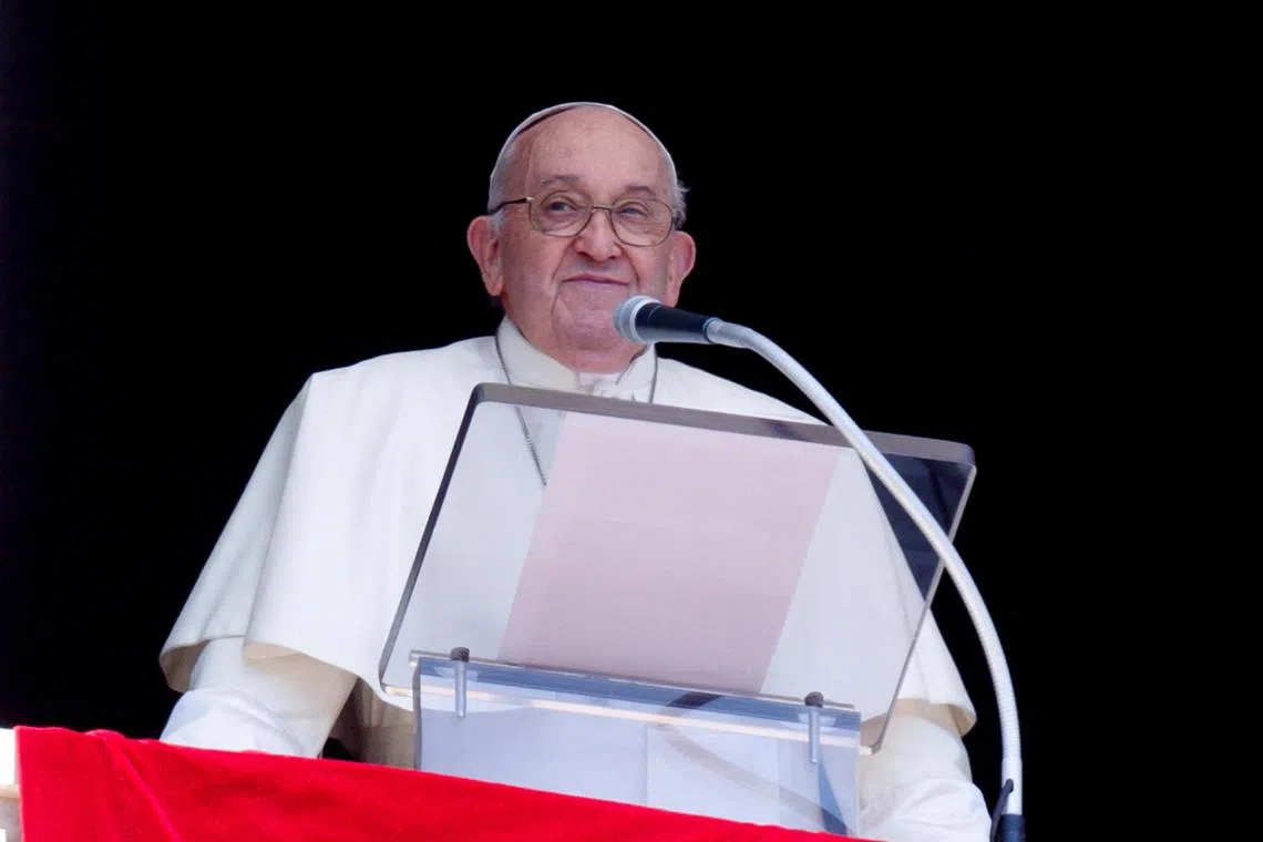 Pope Francis leads the Regina Caeli prayer from his window at the Vatican, on April 14.