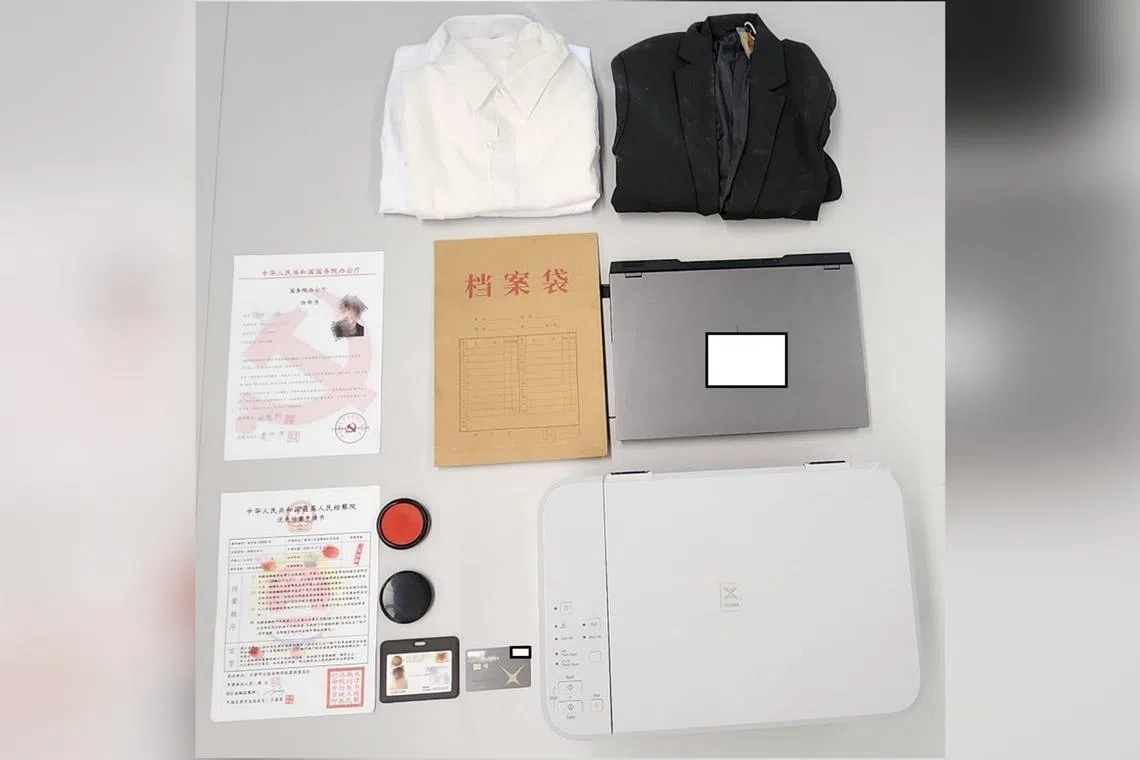 Items seized from Li Jiarui's home, included a laptop, a printer, a brown envelope, a fake MAS pass and a debit card.