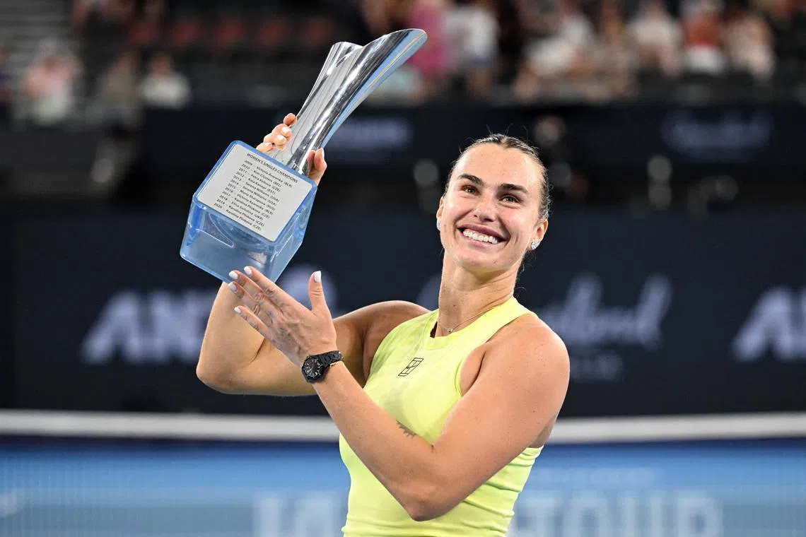 Tennis - Brisbane International Tennis Tournament - Pat Rafter Arena, Brisbane, Australia - January 11, 2026 Belarus' Aryna Sabalenka celebrates with the trophy after winning the final against Ukraine's Marta Kostyuk REUTERS/Dan Peled