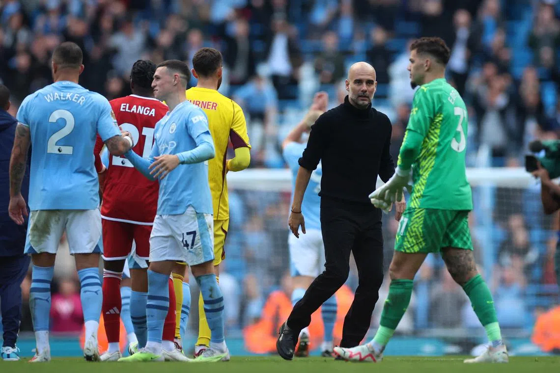 Manchester City manager Pep Guardiola celebrates with his players after the 2-0 win over Nottingham Forest on Sept 23.