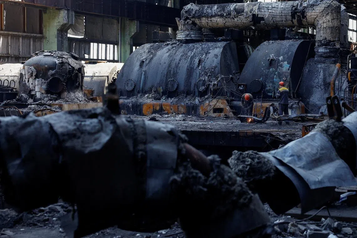 FILE PHOTO: Employees work at a thermal power plant heavily damaged by recent Russian missile strikes, amid Russia's attack on Ukraine, in an undisclosed location in Ukraine April 12, 2024. REUTERS/Valentyn Ogirenko/File Photo