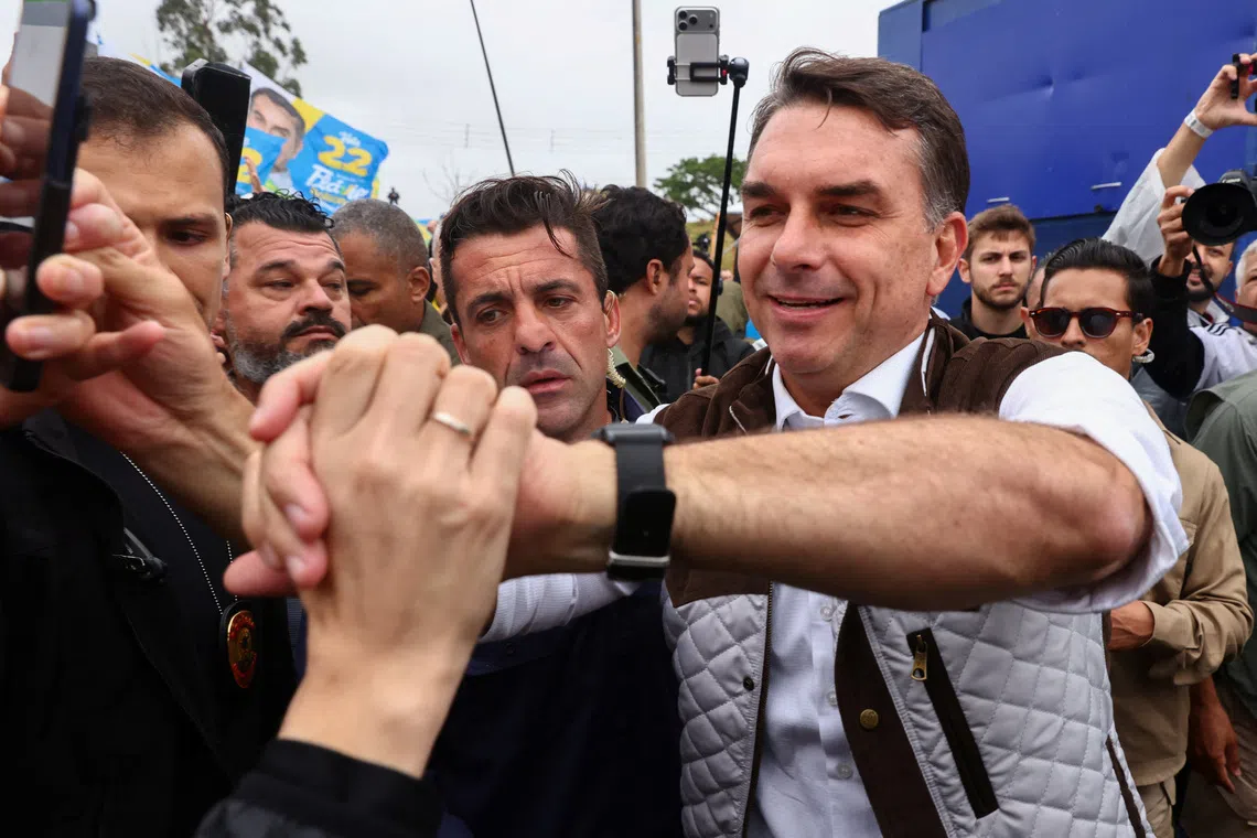Brazilian presidential candidate Flavio Bolsonaro of the Liberal Party (PL) campaigns in the Sarandi neighborhood, one of the areas hardest hit by the historic floods in 2024, in Porto Alegre, Brazil, October 14, 2026. REUTERS/Diego Vara