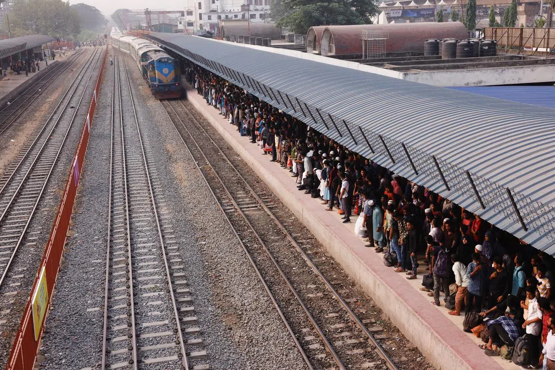 FILE PHOTO: People wait for trains at the Airport Railway Station, to go home ahead of Eid al-fitr, in Dhaka, Bangladesh, April 29, 2022. REUTERS/Mohammad Ponir Hossain/File Photo