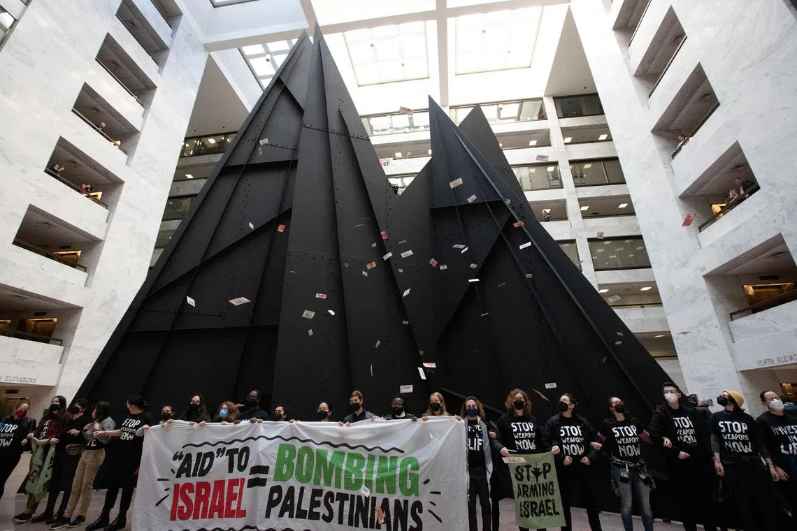 Activists demonstrate in the Hart Senate Office Building atrium to call for a redirection of military aid for Israel.
