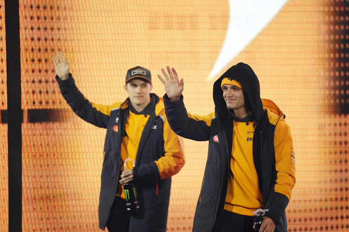 McLaren drivers Oscar Piastri (right) of Australia and Lando Norris of Britain waving on the drivers' parade before the Formula One Las Vegas Grand Prix at the Las Vegas Strip Circuit on Nov 22, 2025.