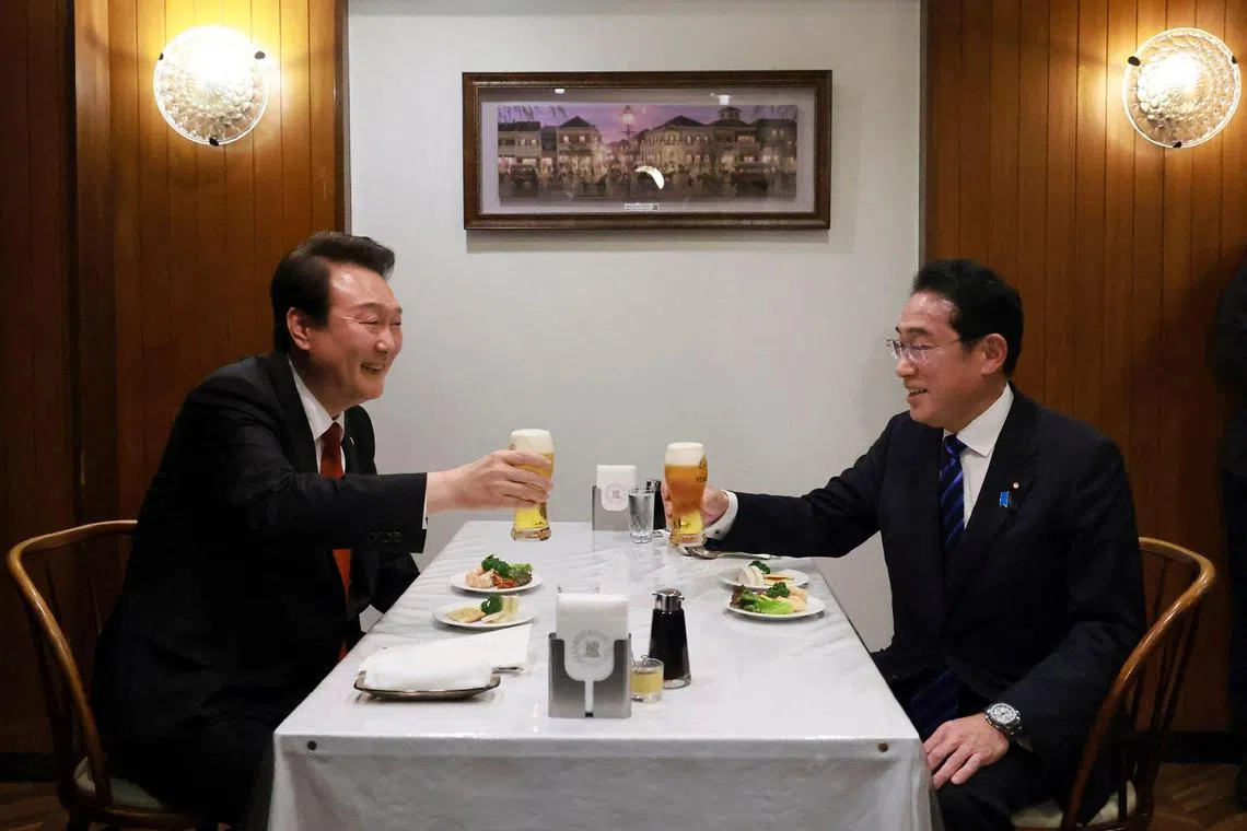 This handout photo taken on March 16, 2023 and released by Cabinet Public Affairs Office of Japan via Jiji Press shows Japan's Prime Minister Fumio Kishida (R) and South Korea's President Yoon Suk Yeol (L) making a toast at a restaurant in Ginza, Tokyo. (Photo by Handout / JAPAN'S CABINET PUBLIC RELATIONS OFFICE VIA JIJI PRESS / AFP) / Japan OUT / -----EDITORS NOTE --- RESTRICTED TO EDITORIAL USE - MANDATORY CREDIT "AFP PHOTO / Cabinet Public Affairs Office of Japan via Jiji Press" - NO MARKETING - NO ADVERTISING CAMPAIGNS - DISTRIBUTED AS A SERVICE TO CLIENTS