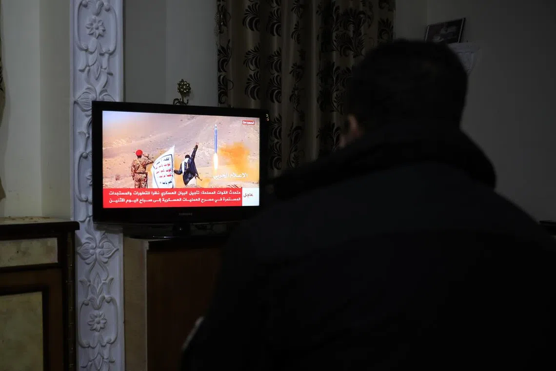News is reported on a Houthis-run TV after a US-registered ship came under attack in the Red Sea in Yemen on Feb 19, 2024.