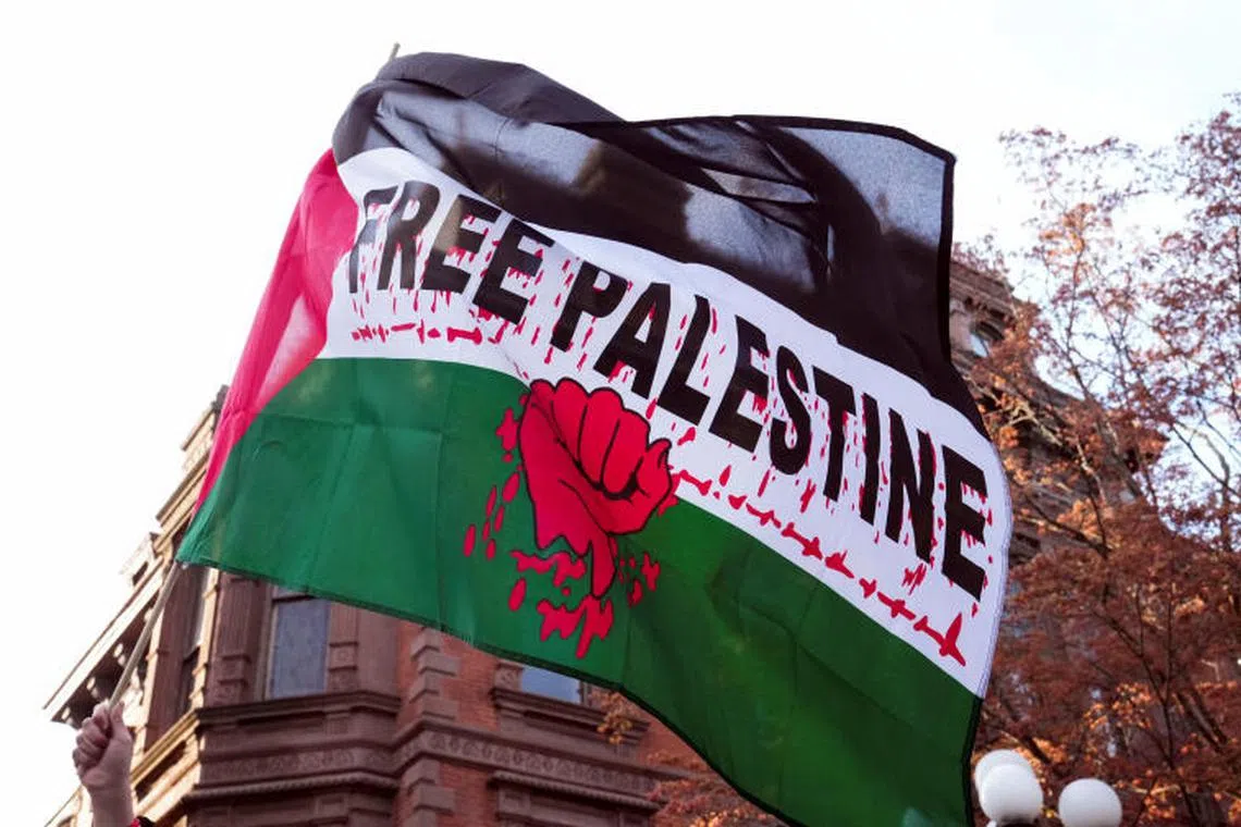 A person holds a flag that says "Free Palestine" during a protest against a planned speech by Israel's National Security Minister Itamar Ben-Gvir, a far-right member of Prime Minister Benjamin Netanyahu's government, to Yale-based Jewish society Shabtai in New Haven, Connecticut, U.S. April 23, 2025. REUTERS/Michelle McLoughlin