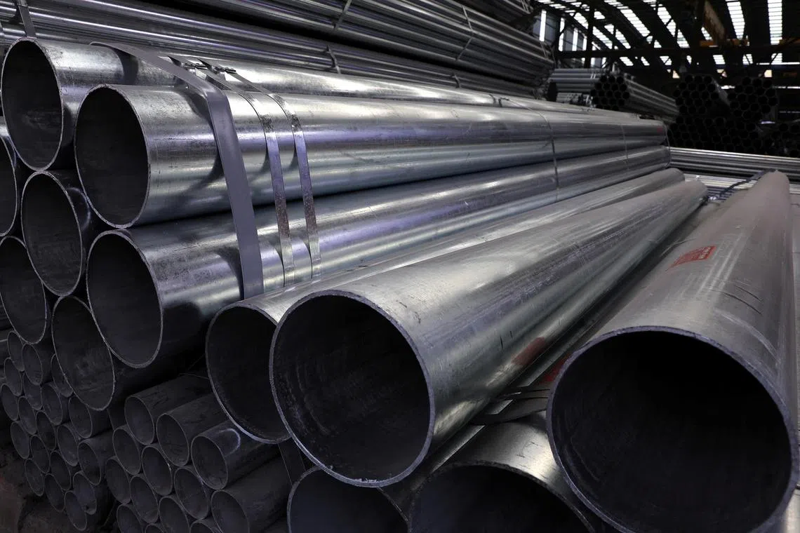 FILE PHOTO: Steel pipes are seen stacked at an industrial park in Shenyang, Liaoning province, China September 30, 2021. REUTERS/Tingshu Wang/File Photo