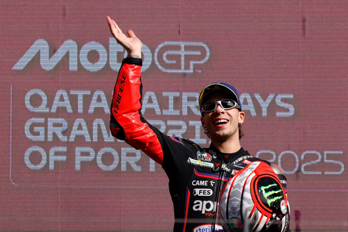 MotoGP - Portuguese Grand Prix - Algarve International Circuit, Portimao, Portugal - November 9, 2025 Aprilia Racing's Marco Bezzecchi celebrates on the podium after winning the MotoGP race REUTERS/Marcelo Del Pozo