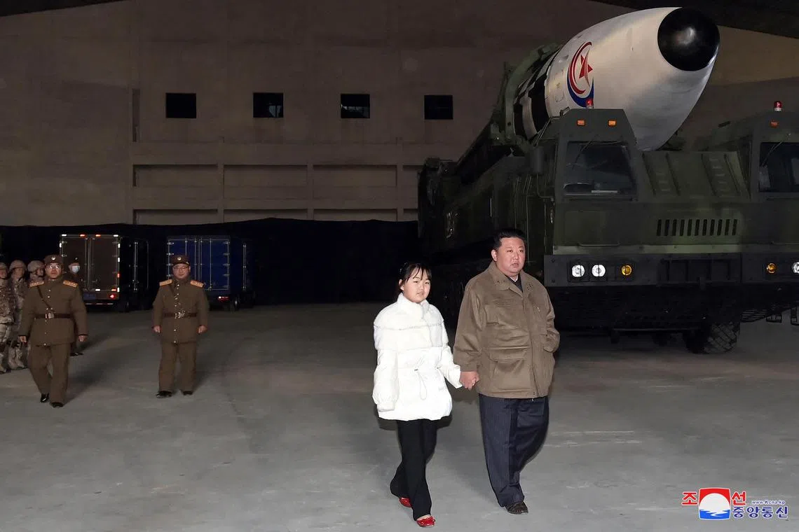 North Korean leader Kim Jong Un, along with his daughter, inspects an intercontinental ballistic missile on Nov 19, 2022.