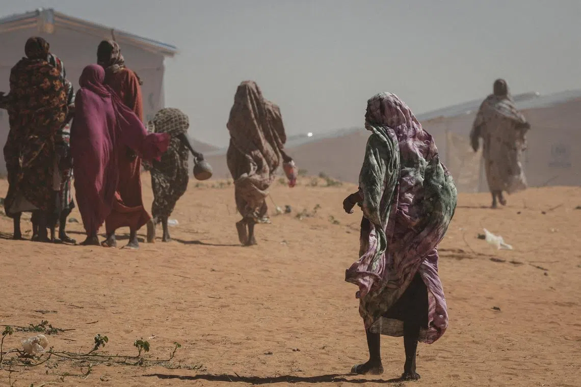 FILE PHOTO: Sudanese refugee women walk at the Tulum refugee camp, amid ongoing conflict in Sudan between the paramilitary Rapid Support Forces (RSF) and the Sudanese army, in Wadi Fira province, eastern Chad, November 30, 2025. REUTERS/Amr Abdallah Dalsh/File Photo